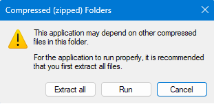 A pop-up warning window titled "Compressed (zipped) Folders" advises extracting files for proper application functionality. Options are "Extract all," "Run," and "Cancel."