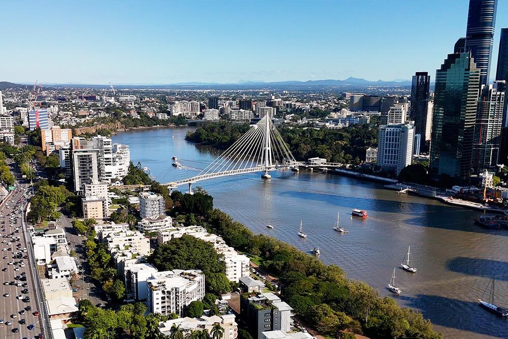 arial shot of a city looking on a bridge over a river