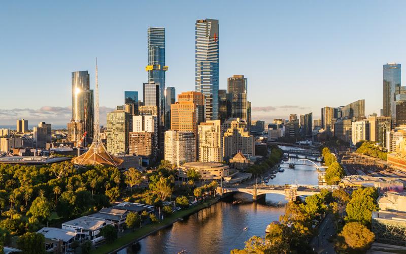 An aerial/drone view onto the city of Melbourne, Victoria, Australia at sunrise.