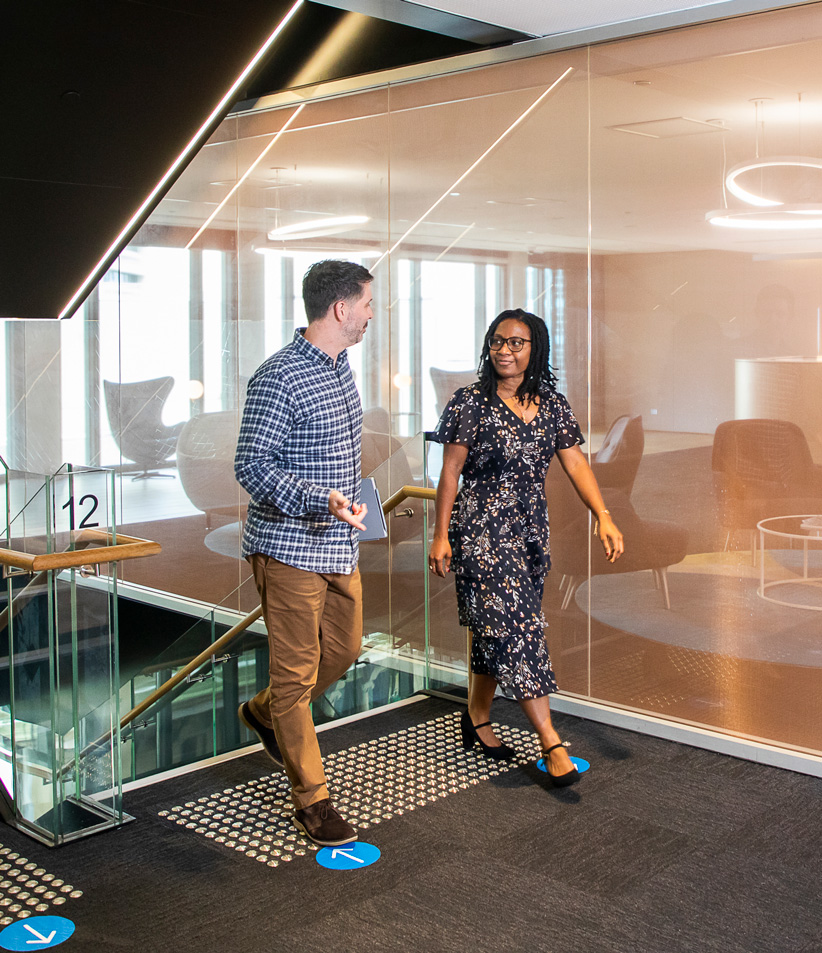 Two employees talking in office location